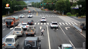 石砖掉落街头堵路  热心市民车流中清障